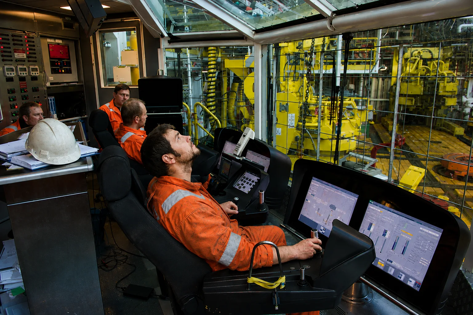 Oil and gas industry professionals reviewing an operating facility